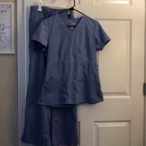 Light Blue Grey’s Anatomy scrubs.